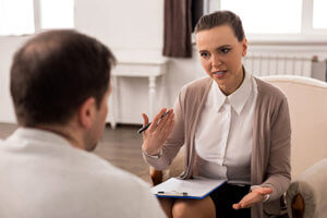 a woman discusses substance abuse treatment jobs with a candidate